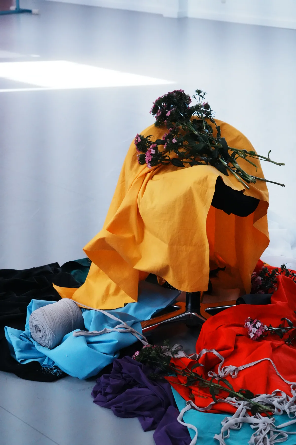 A temporary installation made with fabric, flowers and found materials
