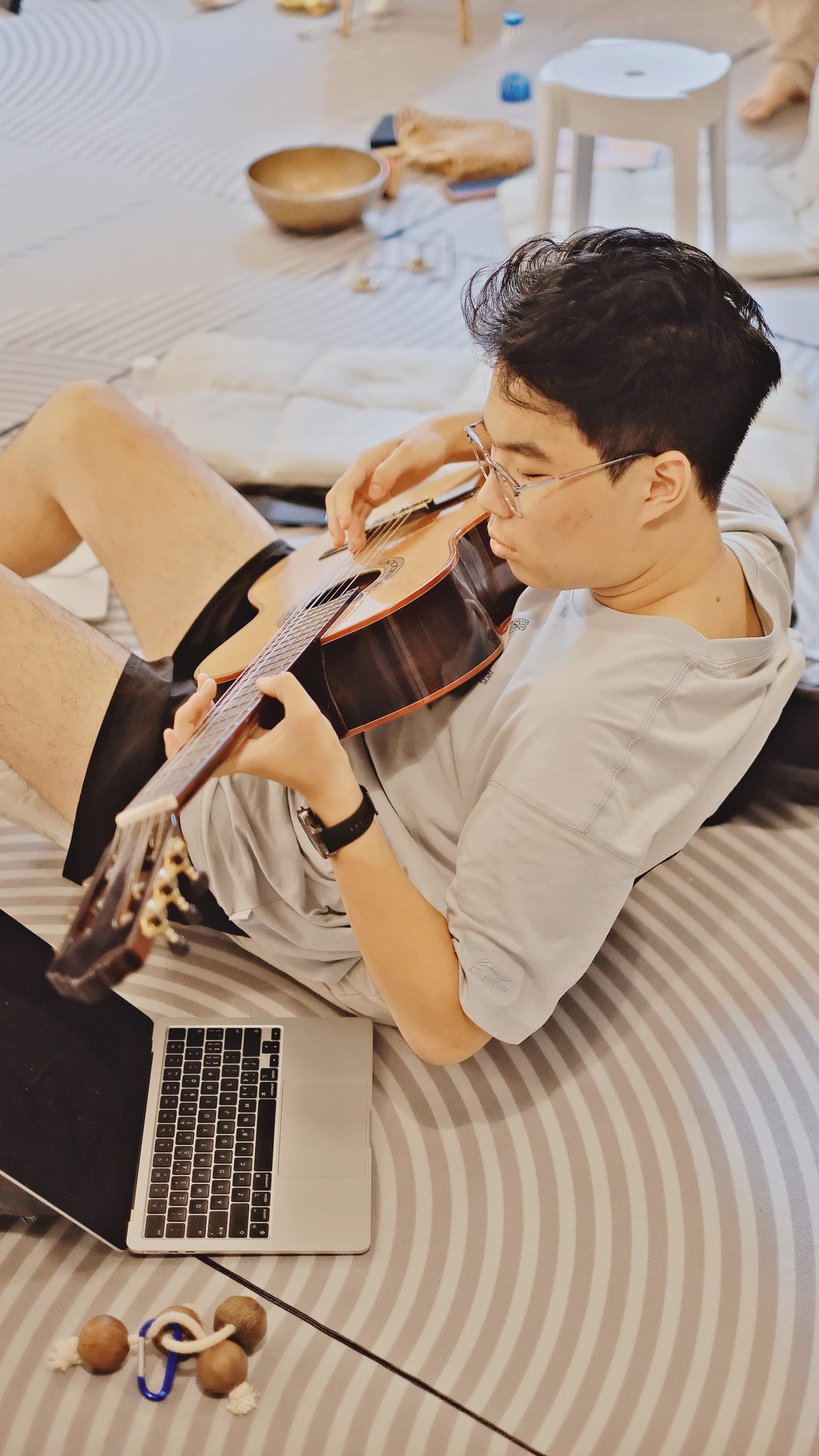 A participant exploring sound and reflection through guitar