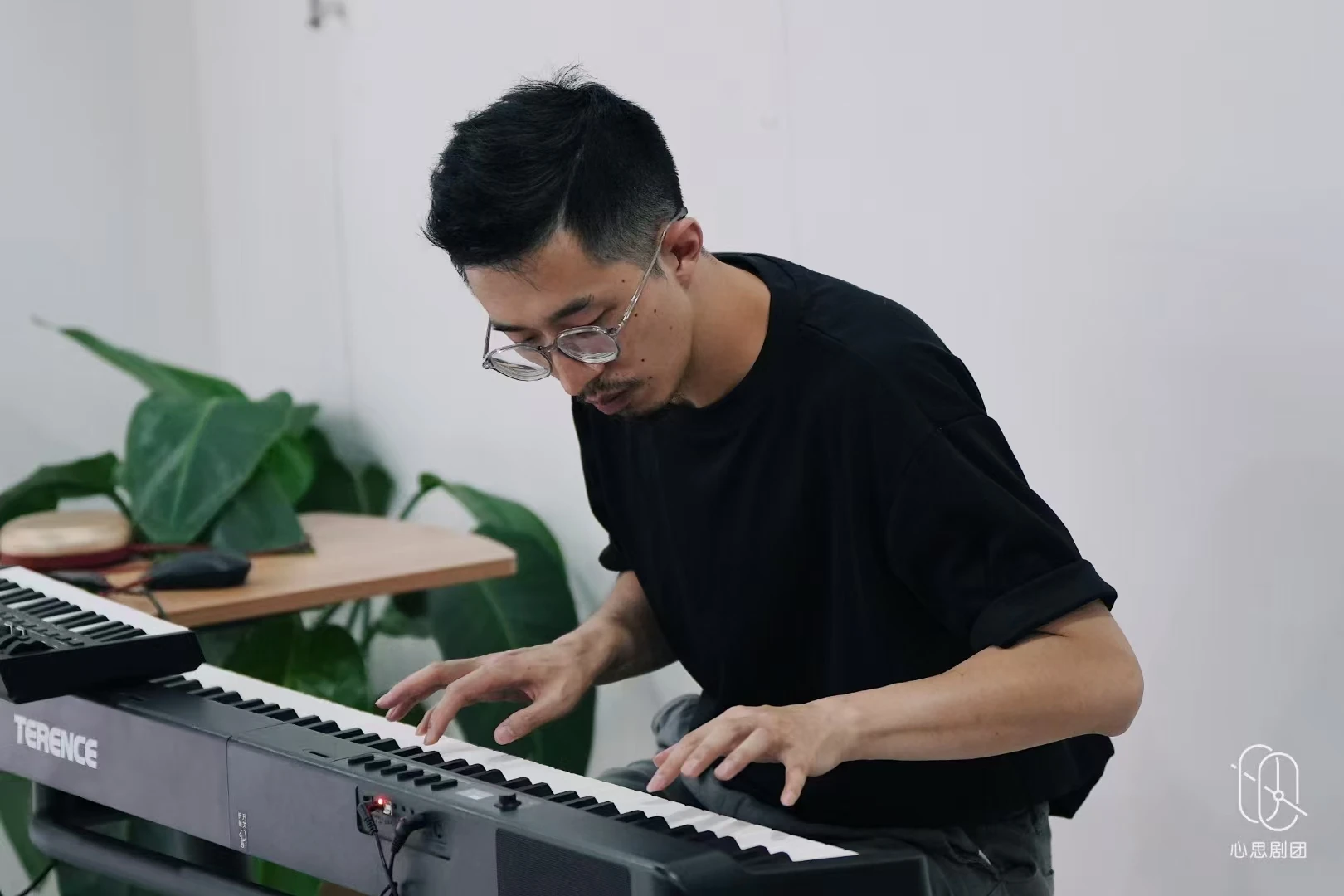 A creative arts practitioner improvising at the keyboard