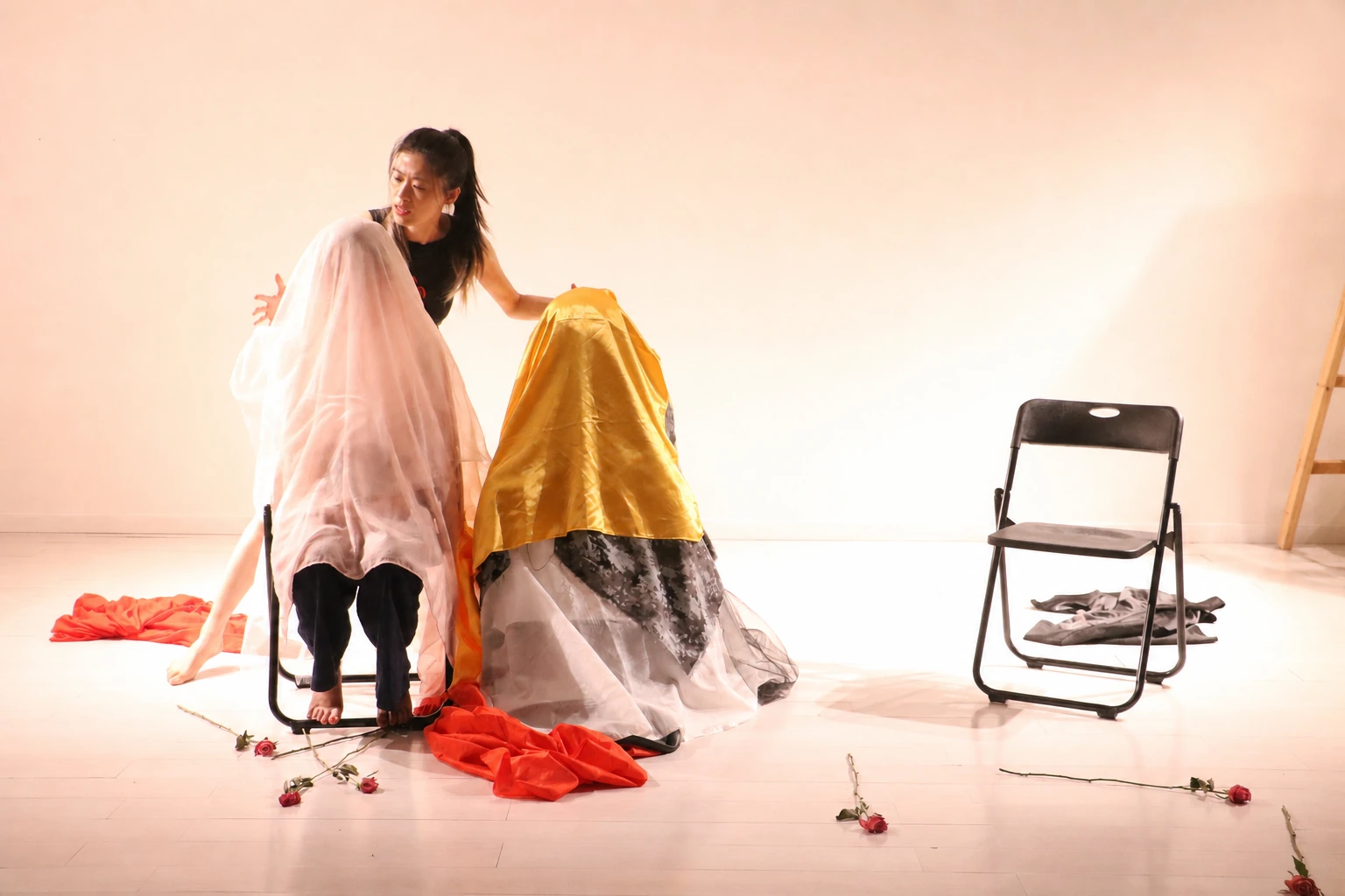 A facilitator guiding an expressive psychodrama performance with fabric and movement